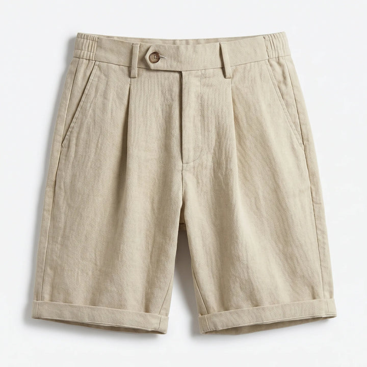 Close-up of men's tailored linen pleated shorts, showcasing fabric texture & stylish turn-up cuff. Summer casual.