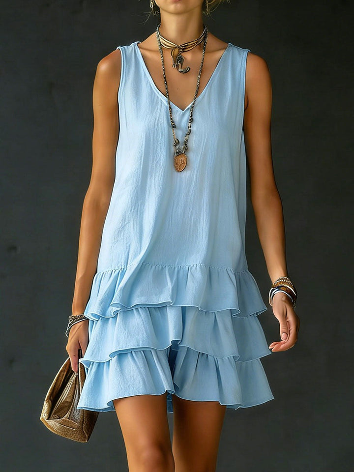 Chic women's V-neck tunic dress with a ruffle hem. Sleeveless summer style, perfect for beach, vacation or casual outings.