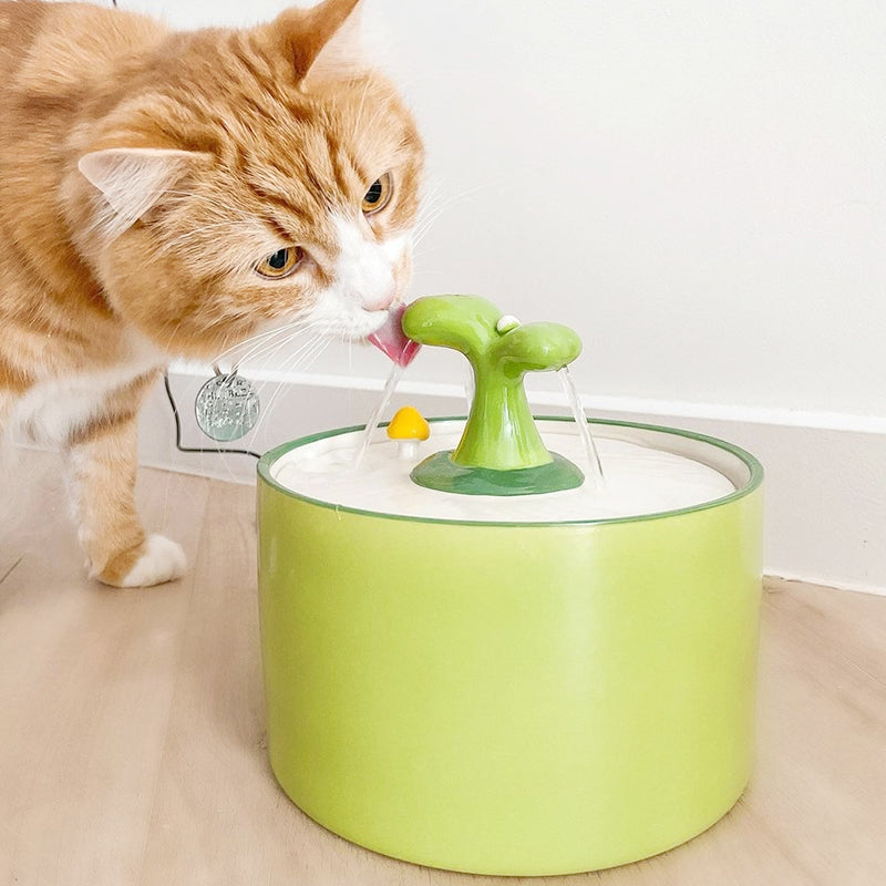 Elegant white ceramic pet fountain, silent & automatic, offers filtered drinking water for cats & small dogs.