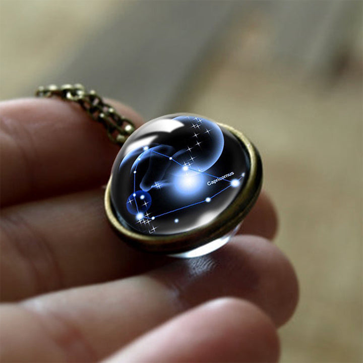 Woman wearing a delicate zodiac sign glass pendant necklace, a spiritual protection accessory.