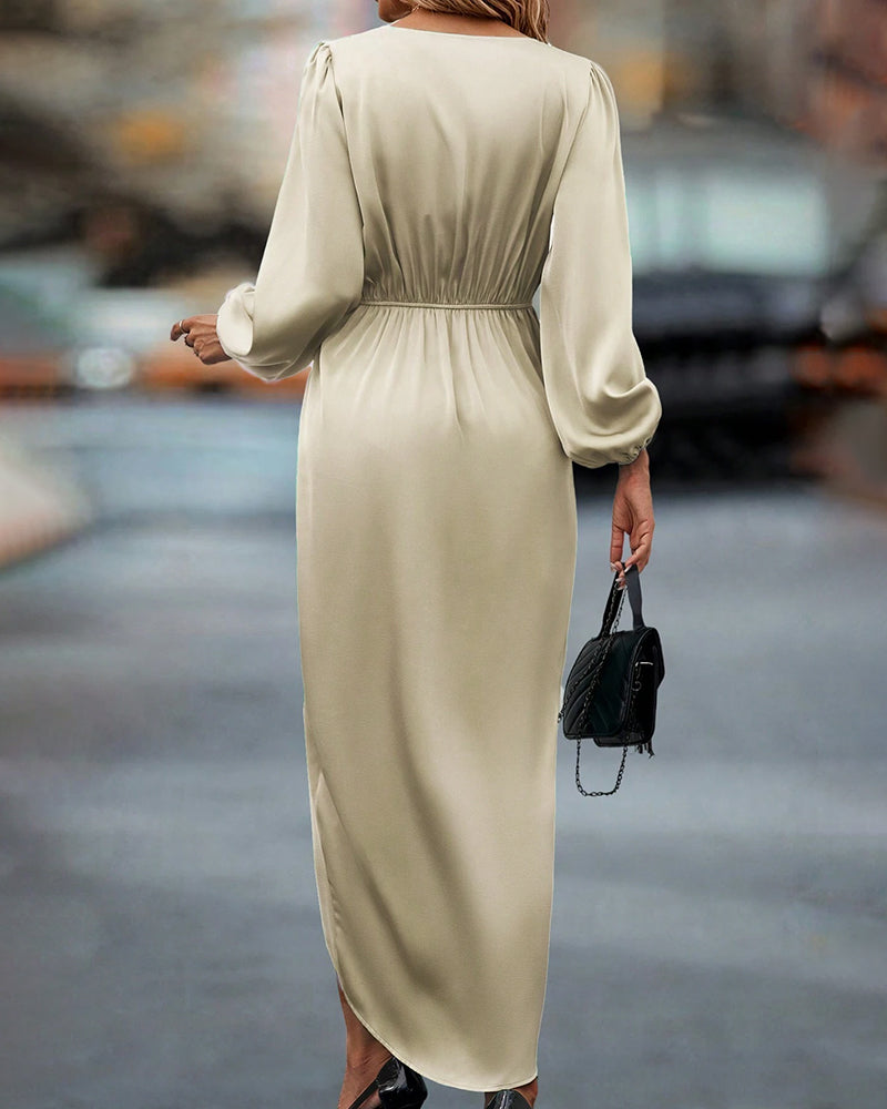 Women's beige V-neck midi dress with elegant lantern sleeves. A-line silhouette, perfect for chic seasonal fashion.