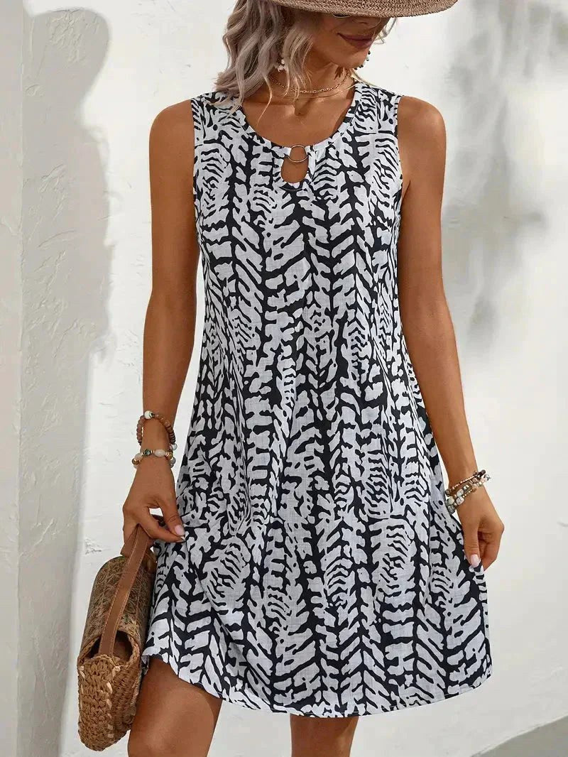 Effortless women's fluid silhouette dress with a vibrant graphic print, perfect for versatile summer styling.