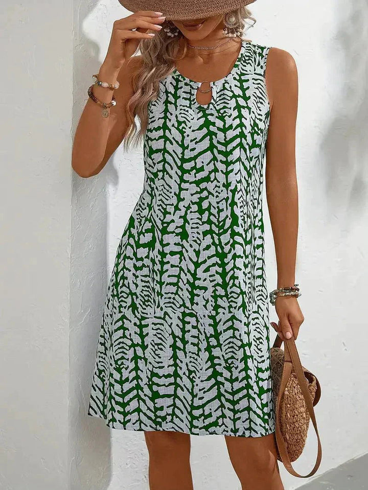 Flowy women's summer dress with a fluid silhouette and eye-catching graphic print, designed for movement.