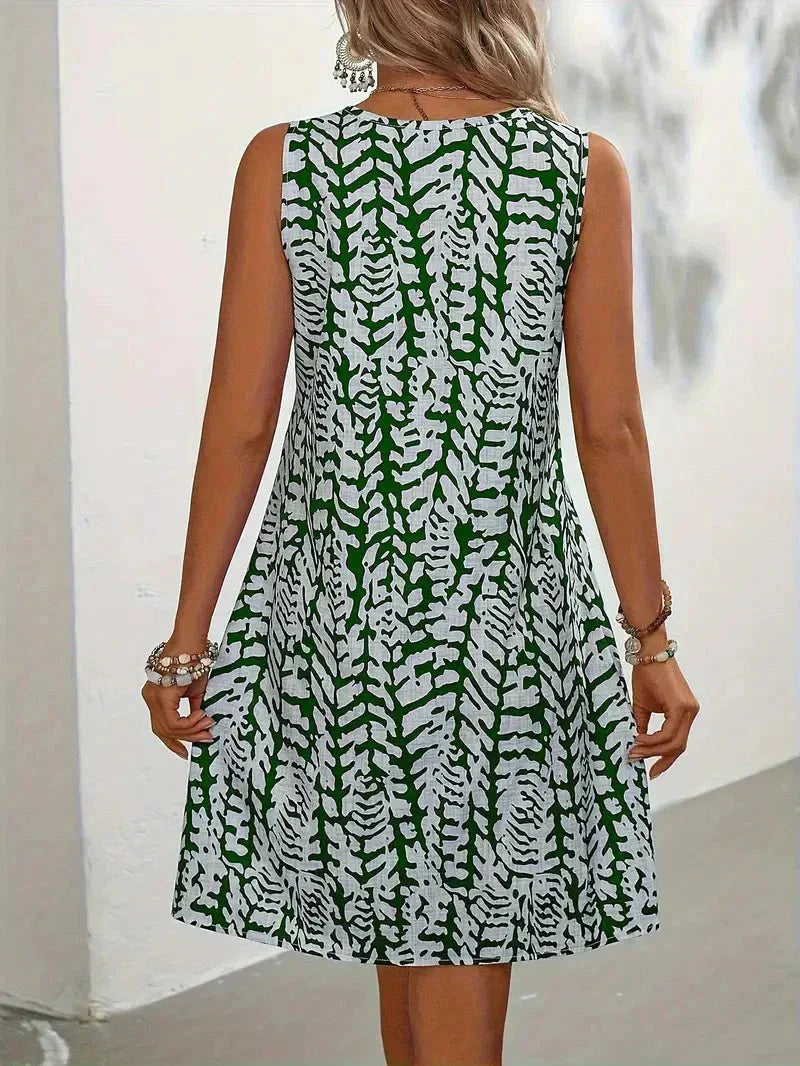 Stylish women's summer dress with an abstract graphic print, featuring a lightweight, fluid, and flowy design.