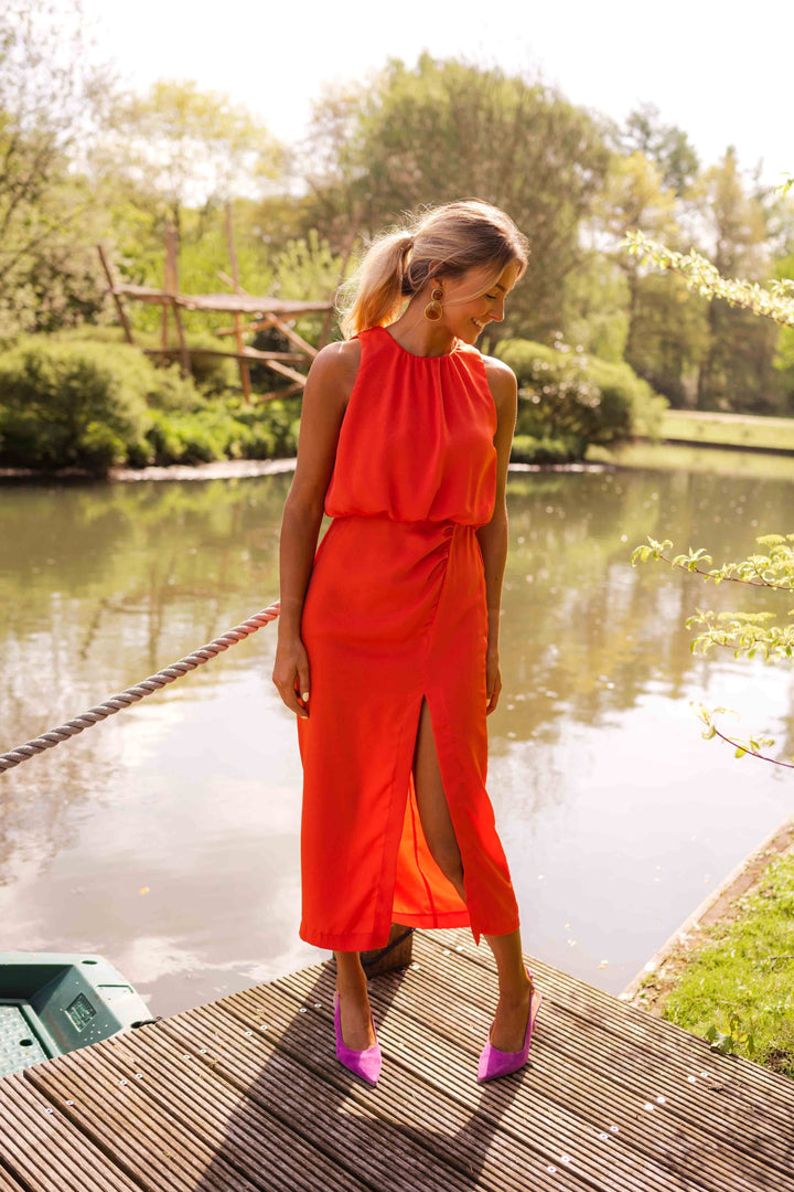 Elegant women's sleeveless midi dress, high neck & side slit design. Sophisticated summer party wear.