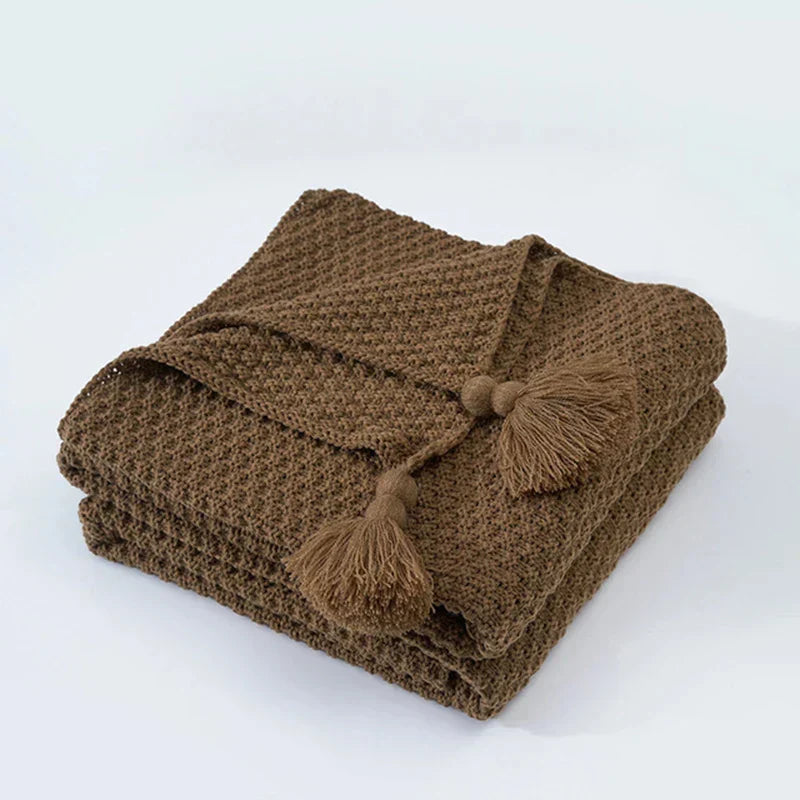 Stylish tassel blanket, soft knitted wool, perfect for chilly evenings on the couch.