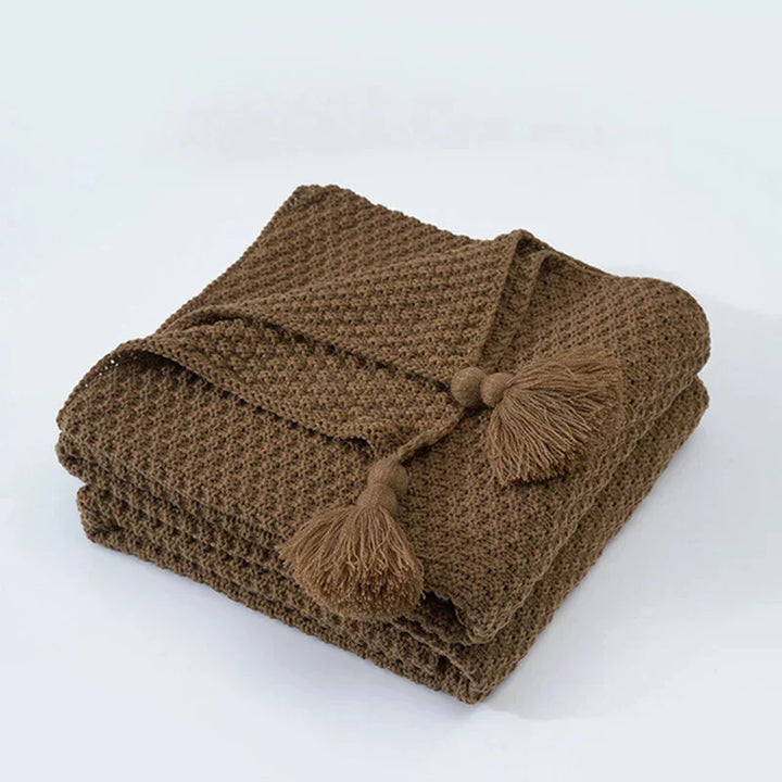 Stylish tassel blanket, soft knitted wool, perfect for chilly evenings on the couch.