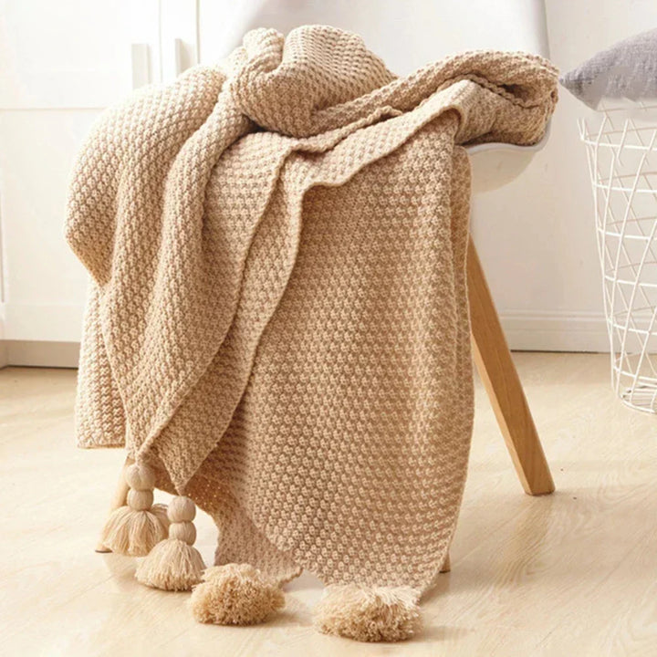 Luxurious wool throw blanket, intricate knitted pattern, offers ultimate comfort & style.