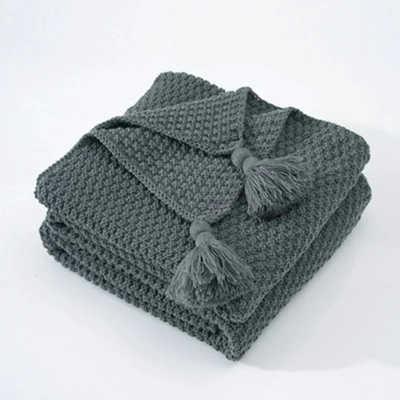 Premium wool blend knitted blanket with tassels, comfortable & chic for cozy home use.