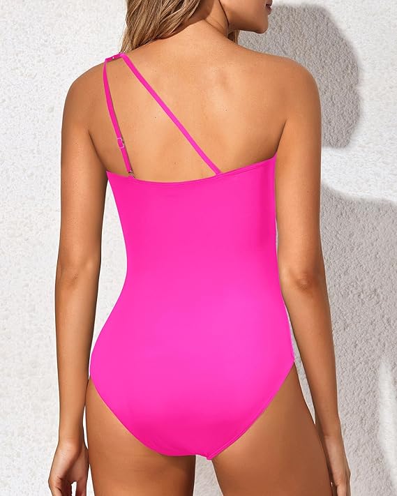 Woman enjoying sun in her stylish one-shoulder tummy control swimsuit. Perfect beachwear.