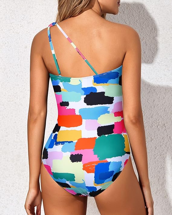 Model wearing a flattering women's one-shoulder tummy control swimsuit by the pool.