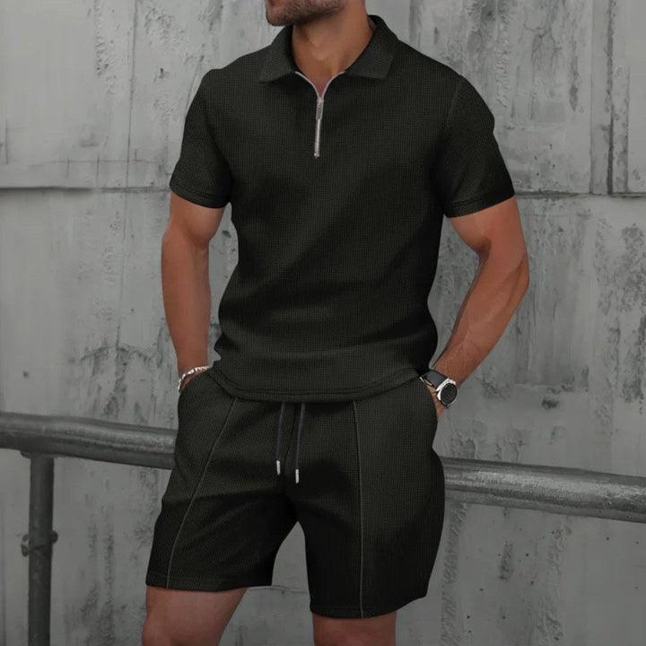 Man wearing an effortless casual men's zip-neck polo & shorts set. Perfect for relaxed summer days.
