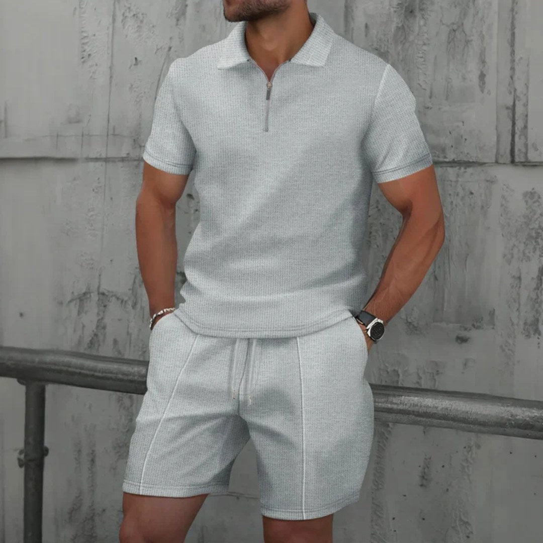 Full outfit: relaxed fit men's zip-neck polo and shorts matching set. Showcasing casual summer style.