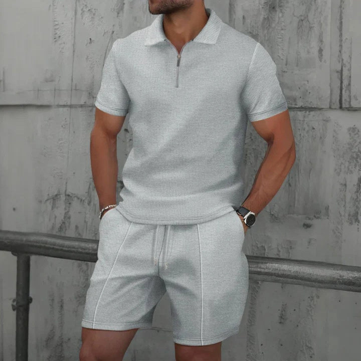 Full outfit: relaxed fit men's zip-neck polo and shorts matching set. Showcasing casual summer style.