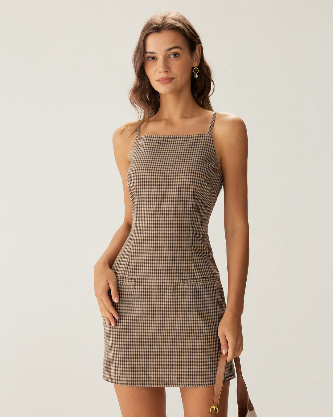 Casual yet elegant brown gingham spaghetti strap mini dress for women, a perfect summer wardrobe addition.