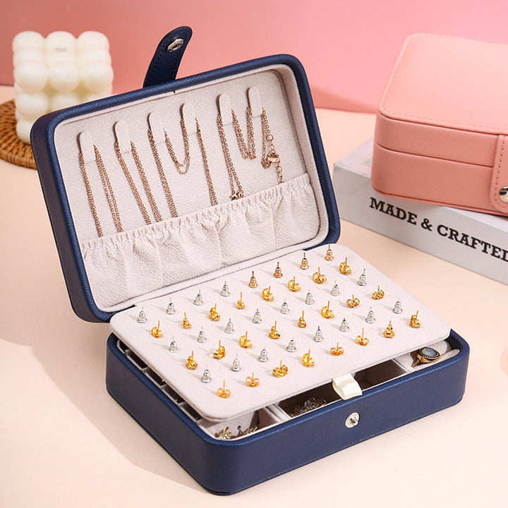 Compact white leather flip-top travel jewelry case, ensuring elegant organization on the go.
