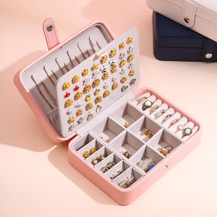 Pink flip-top jewelry organizer for women, an elegant solution for vanity accessories.