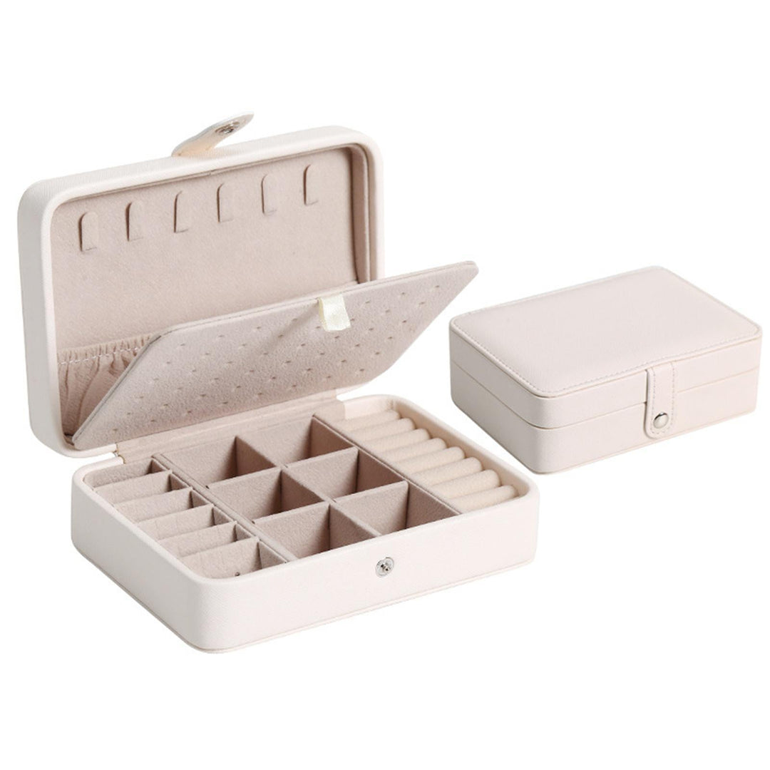 White leather flip-top jewelry box, compact and perfect for travel or desktop organization.