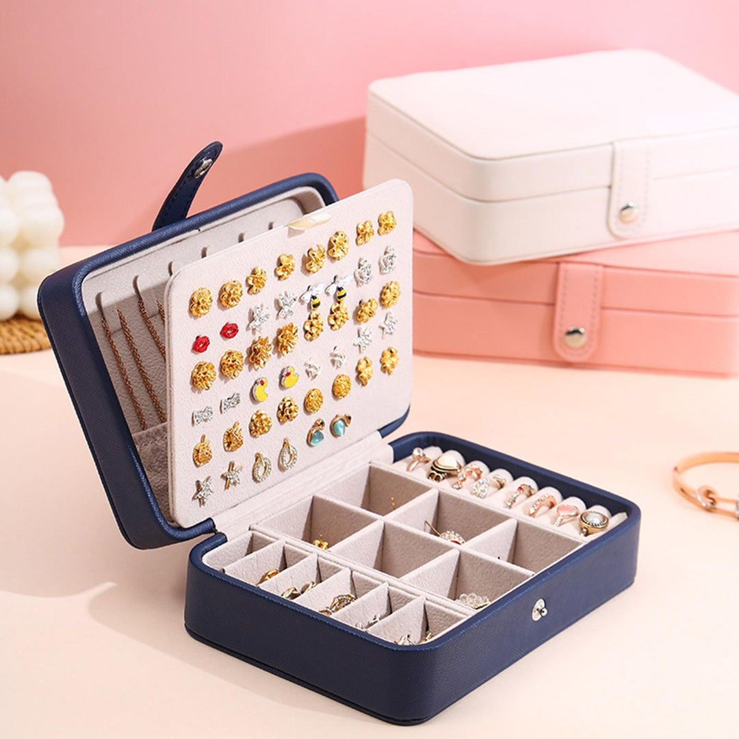 Stylish pink leather flip-top jewelry box, a chic accessory for any women's vanity.