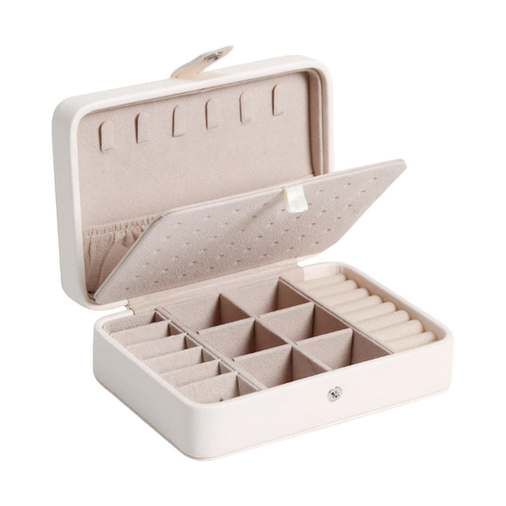 White flip-top leather jewelry organizer, a stylish desktop accessory and travel case.