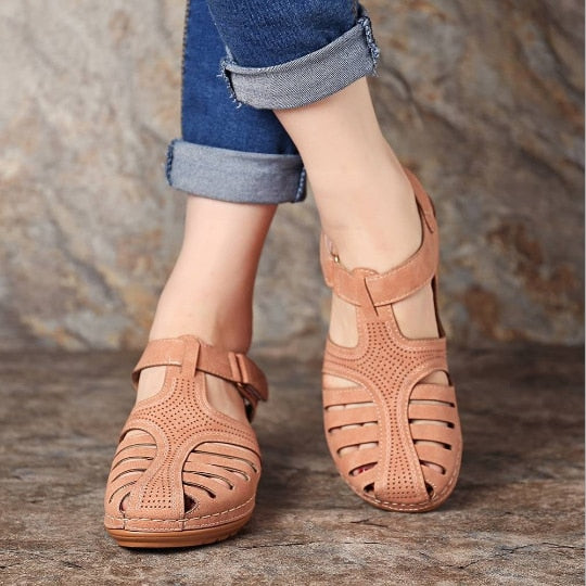 Elegant women's orthopedic sandals with comfortable wedge heel and protective closed toe.