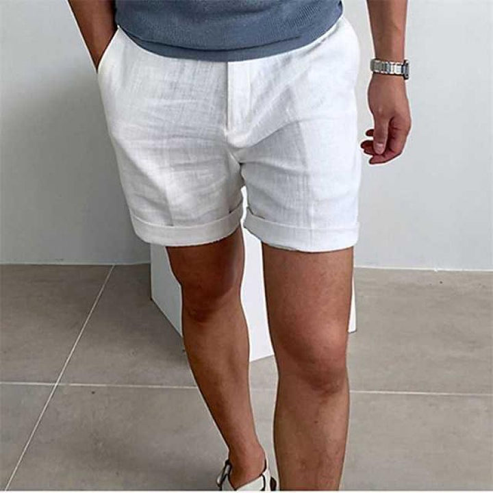 Tailored men's linen shorts with polished rolled cuffs for a versatile summer fashion look.