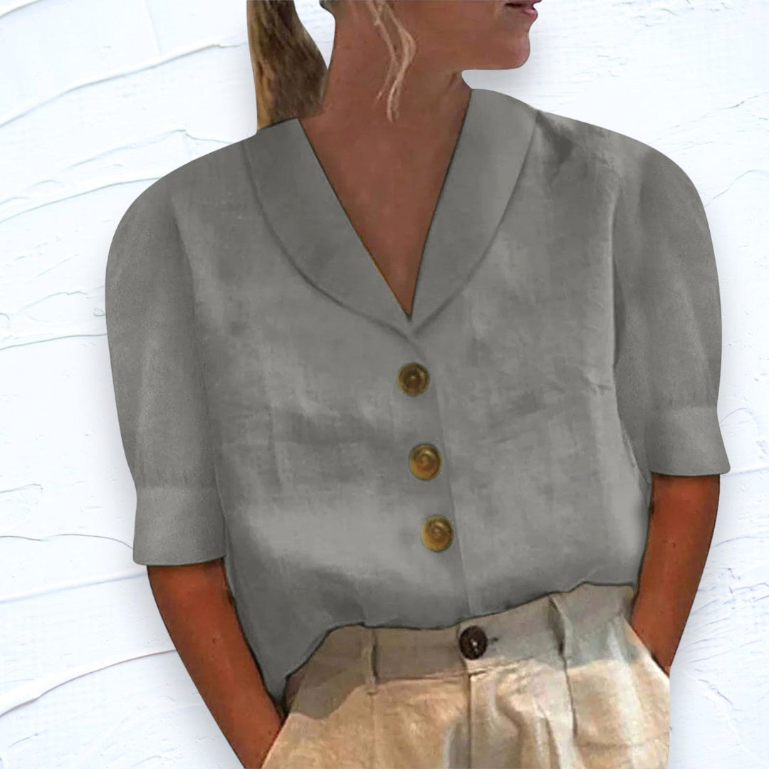 Stylish women's V-neck blouse featuring cap sleeves, perfect for summer fashion and effortless elegance.