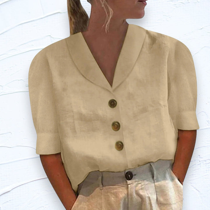 Comfortable women's V-neck cap sleeve top, ideal for casual spring outfits or elegant everyday wear.