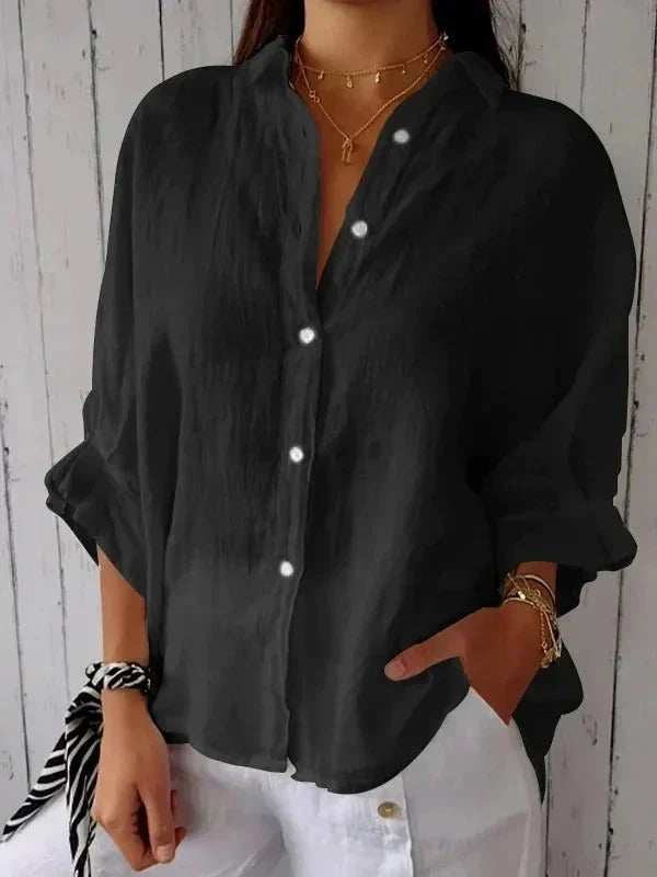 Women's elegant relaxed button-down linen shirt featuring rolled sleeves and a comfortable oversized fit.