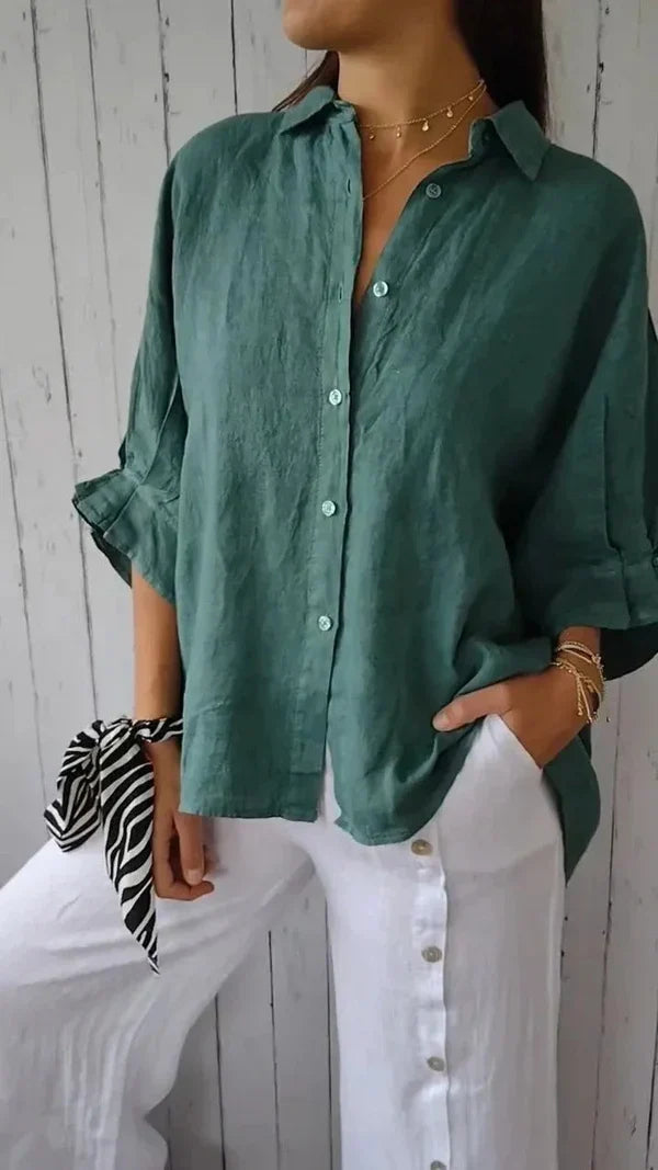 Lightweight women's linen button-down shirt, relaxed fit, with stylish rolled sleeves for a sophisticated casual look.