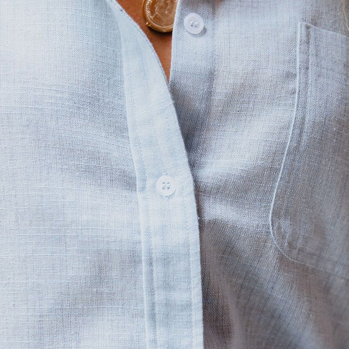 Stylish women's button-up shirt with stand-up collar, chest pocket, & long sleeves. Smart casual ladies fashion.