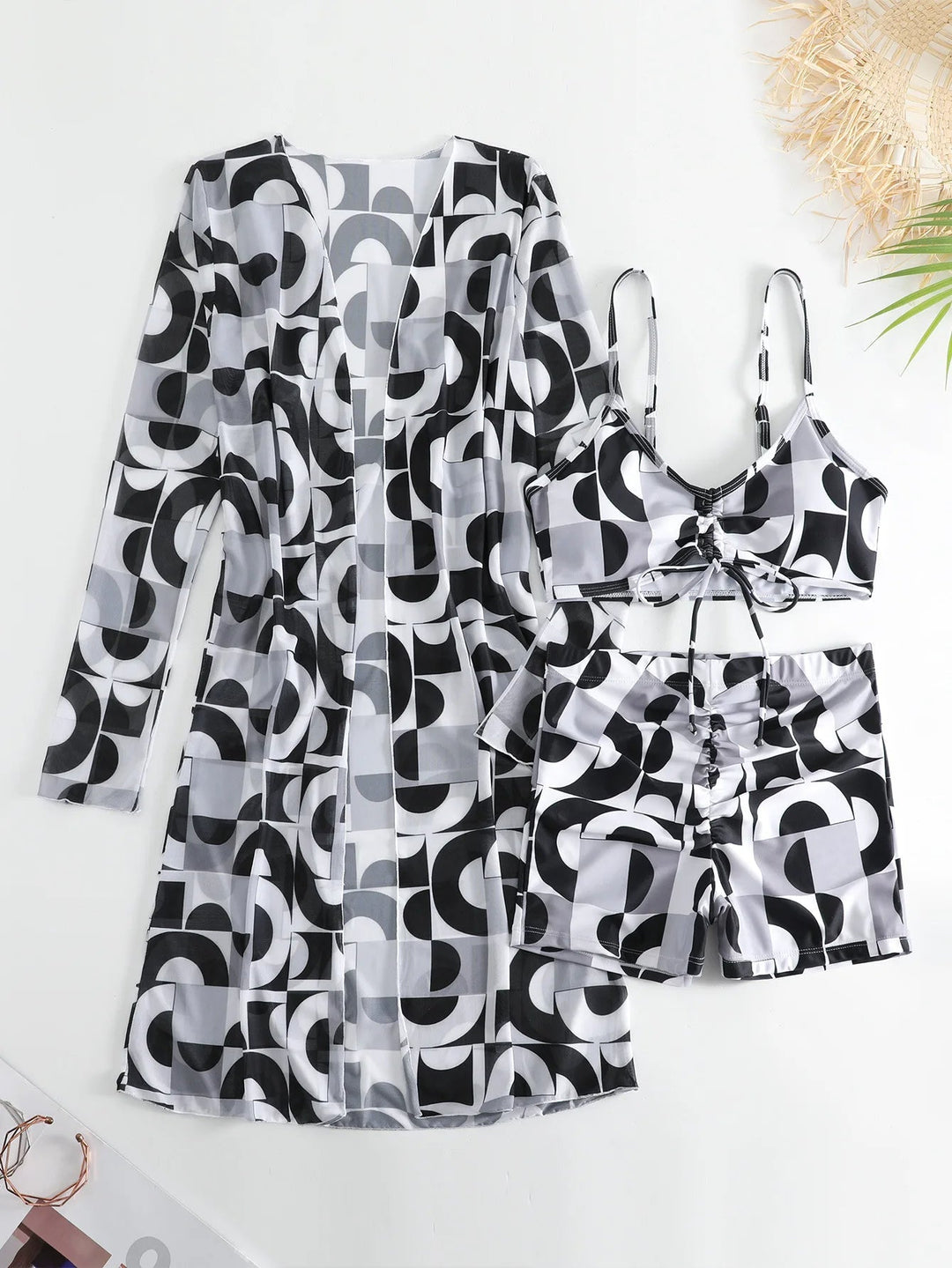 Stylish women's tie-dye long sleeve sheer cover-up, paired with a matching bralette and high-waist shorts.