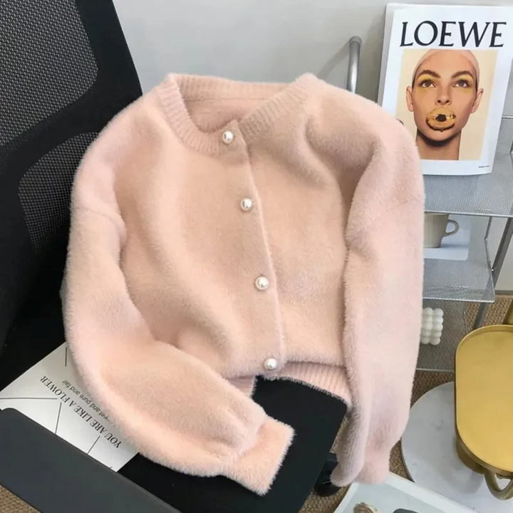 Elegant women's loose knit cardigan with a classic round neck, offering effortless style & comfort.