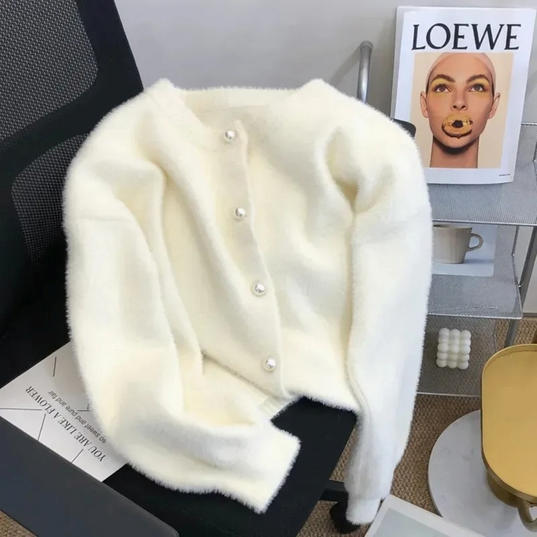 Close-up of a soft loose knit women's cardigan featuring a stylish round neck & relaxed fit.