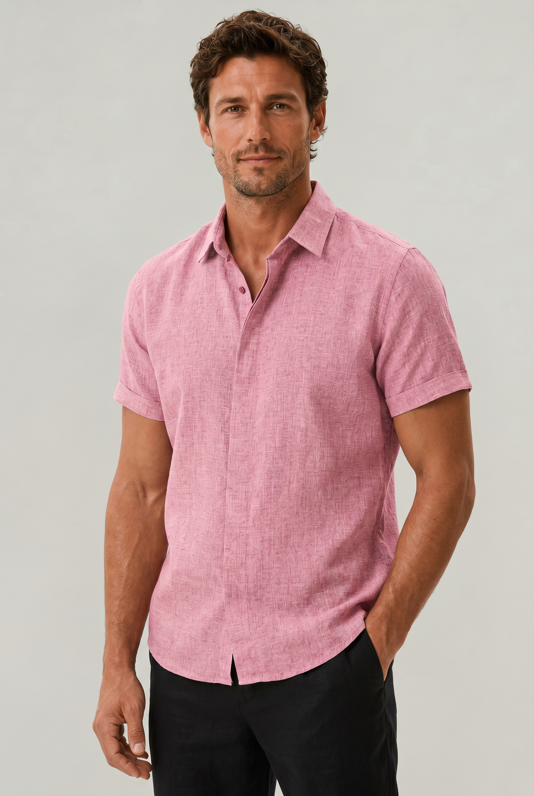 Man wearing a stylish textured short sleeve button-up shirt, demonstrating a smart casual summer look.
