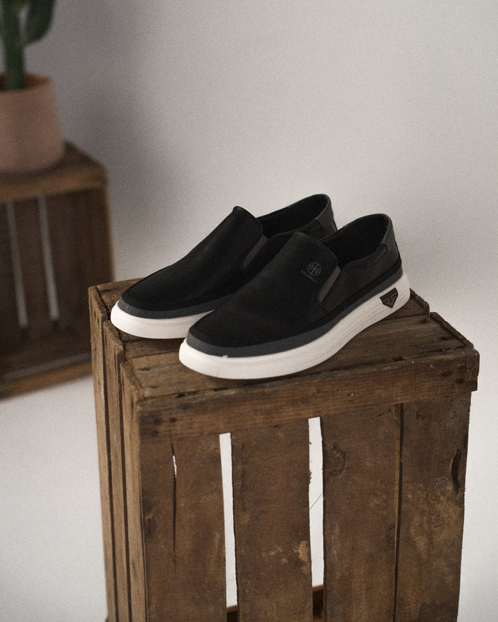 Man wearing black Refined Cushioned Orthopedic Slip-On Walking Shoes, comfortable everyday.