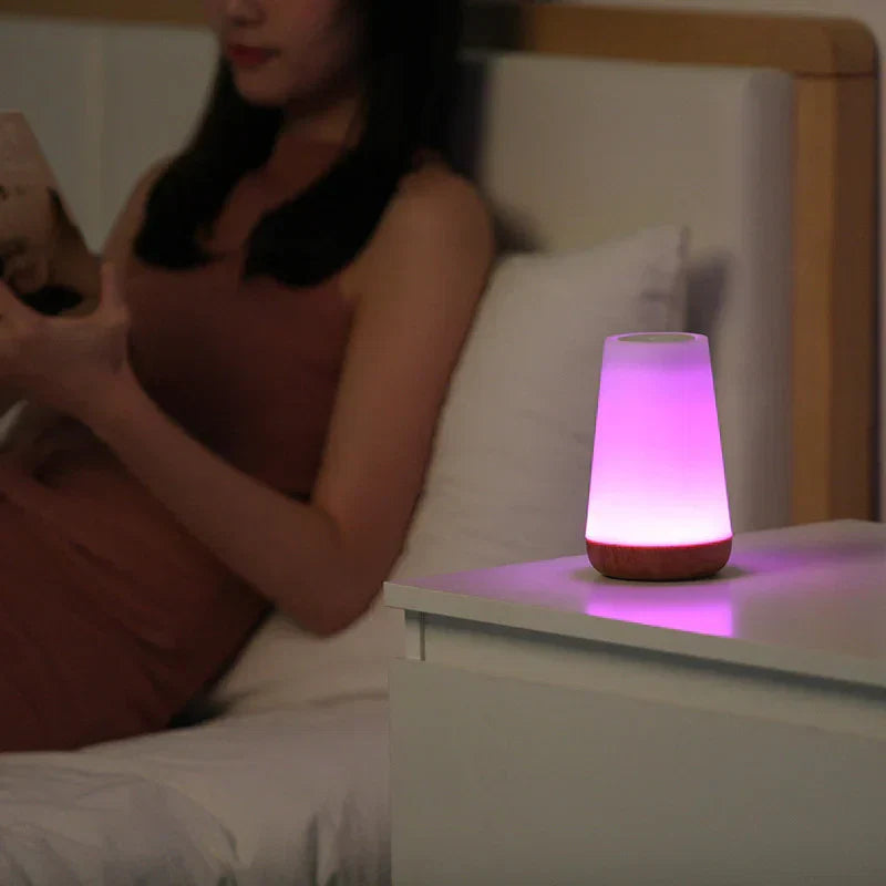 Rechargeable LumiSeren night light with touch control, providing magical mood lighting for any bedside.