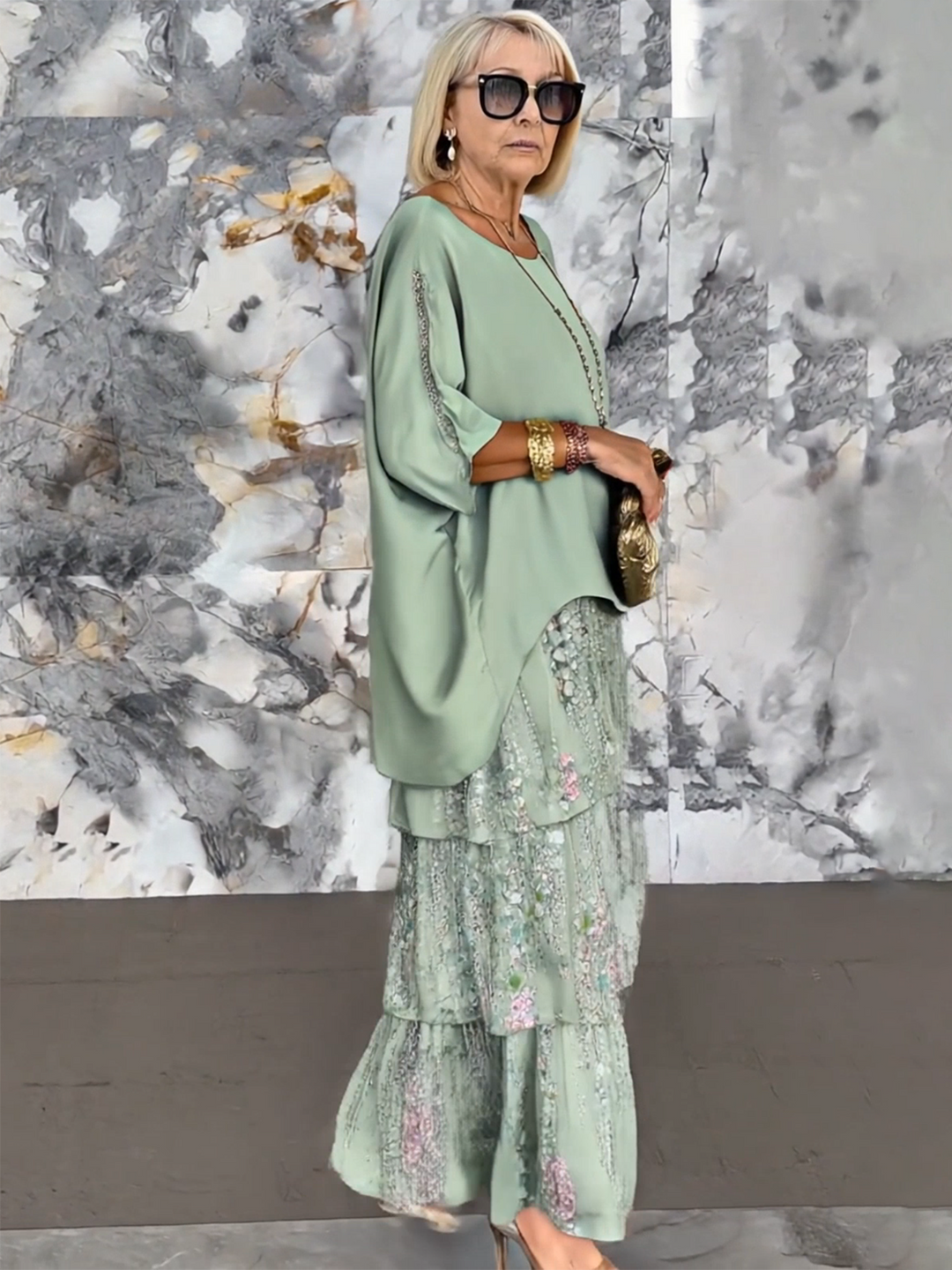 Women's flowing tiered ruffle cocktail dress with stylish batwing sleeves.