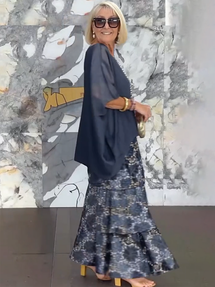 Fashionable women's cocktail dress, tiered ruffles & airy batwing sleeves.