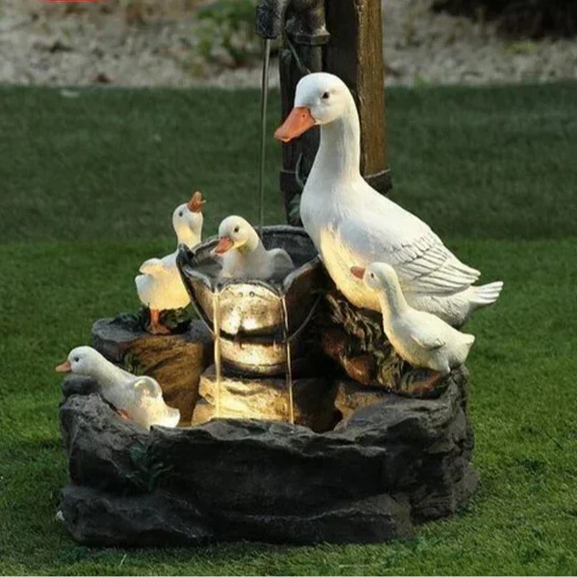 Garden solar water feature with a playful duck figure, illuminated by an LED light. Ideal outdoor decor accent.