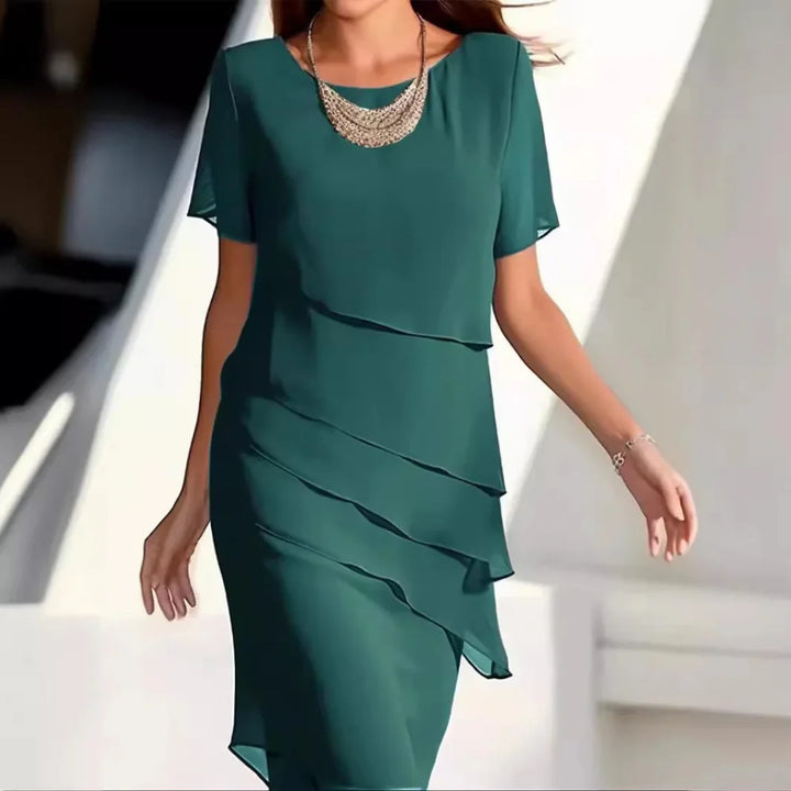 Chic women's blue midi dress featuring a flattering fit, short sleeves & round neck for any elegant occasion.