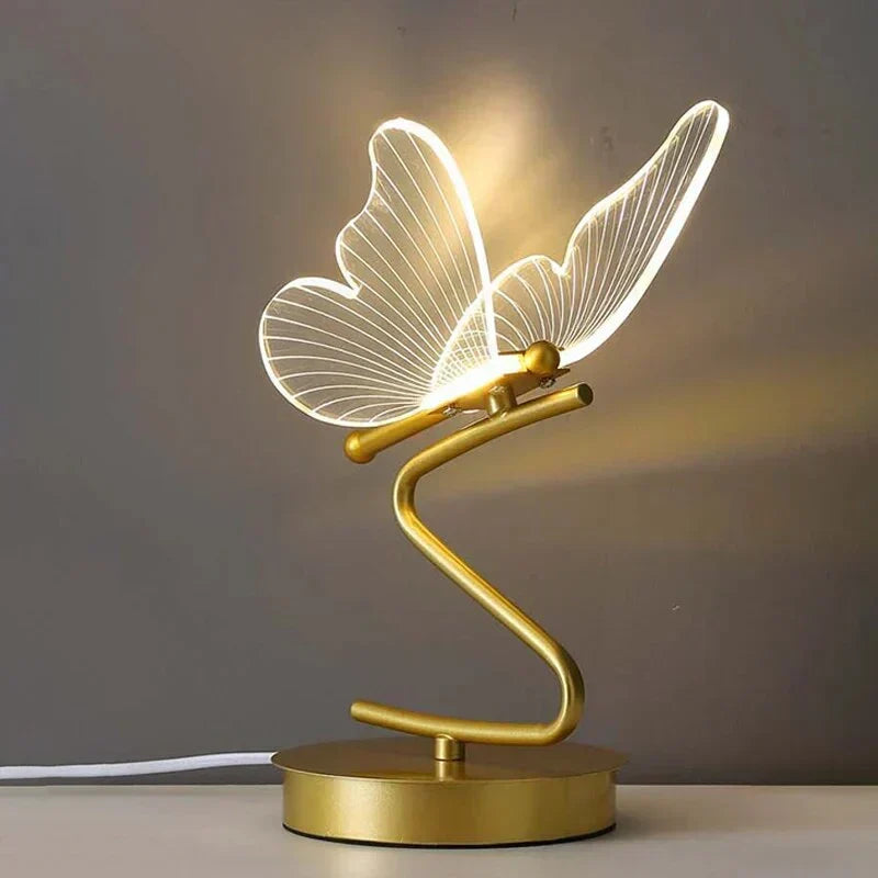 Close-up of elegant gold butterfly detail on a luxury LED table lamp, enhancing modern home decor with warm light.