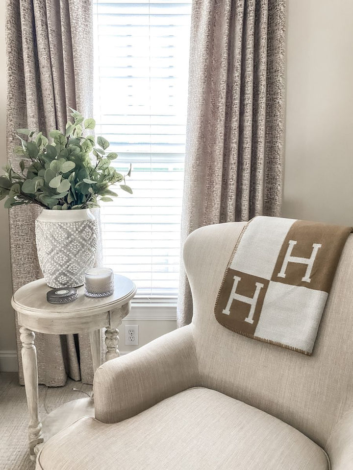 Plush gold cashmere throw, adding warmth and elegance to any room.