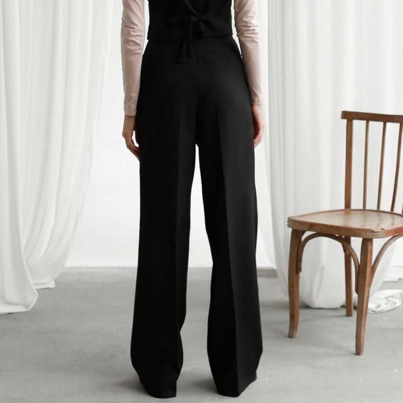 Classic black high waist pleated wide leg pants for women, offering a stylish & comfortable fit.