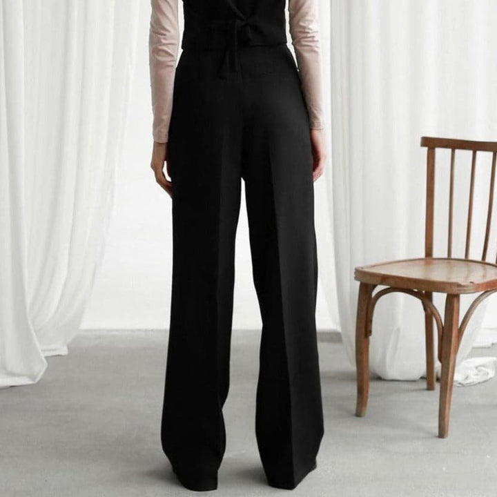 Classic black high waist pleated wide leg pants for women, offering a stylish & comfortable fit.