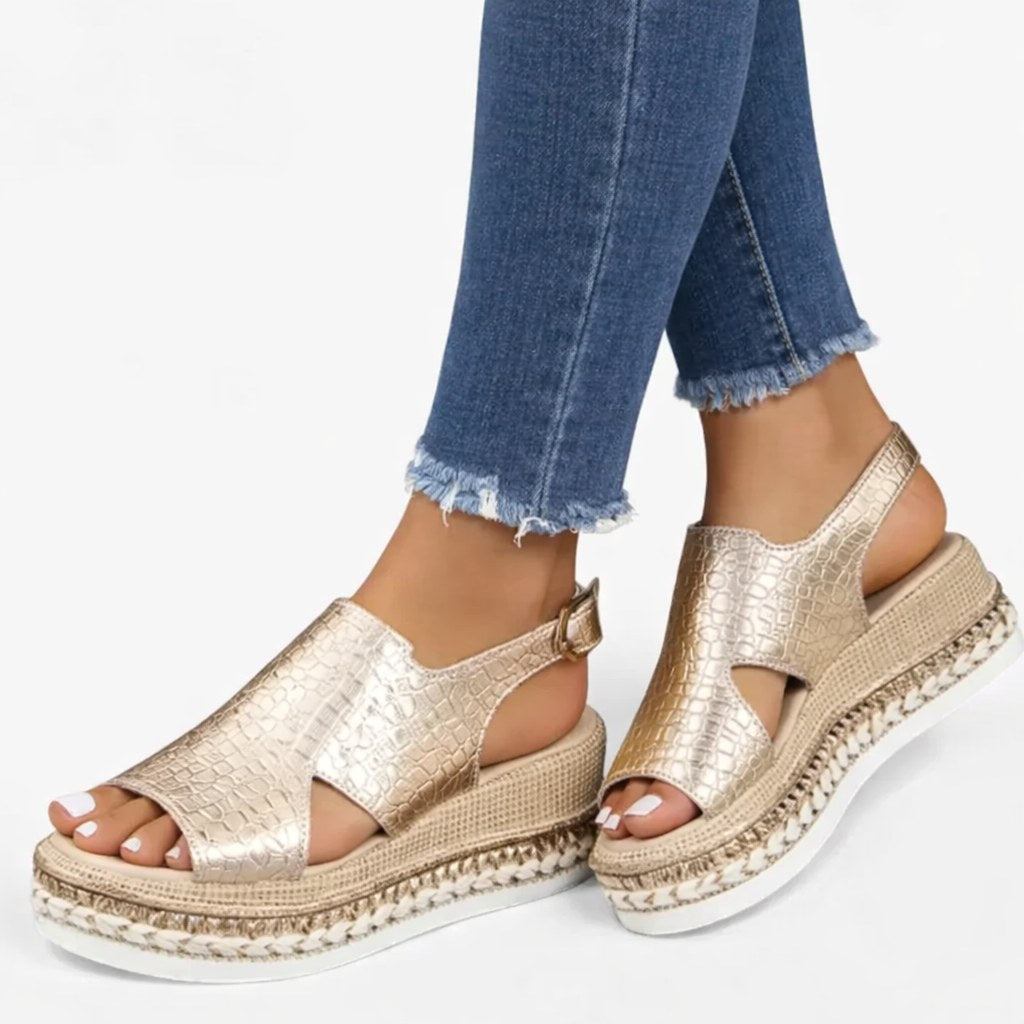 Elegant women's metallic platform wedge sandals, offering supportive comfort and an adjustable strap for summer fashion.