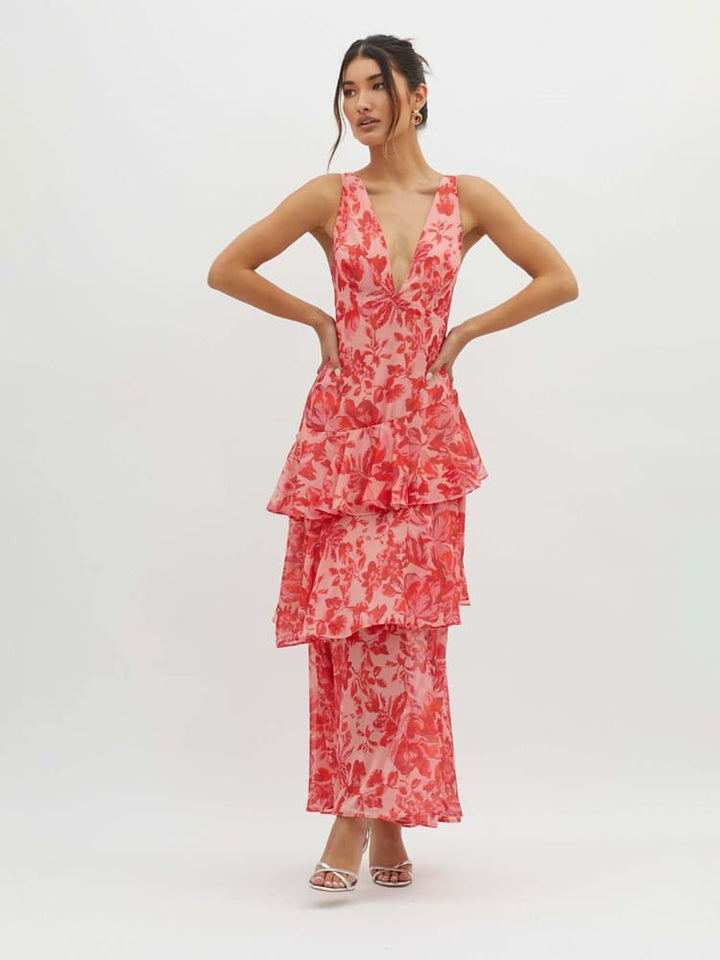Stunning floral tiered maxi dress for women featuring a plunging neckline, strappy back & flowing ruffles. Occasion wear.