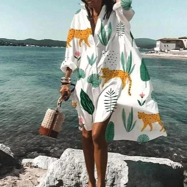 Woman in a flowing white shirt dress, perfect for a casual summer day. Fluid & comfortable elegant style.