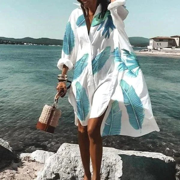 Full length front view of a women's flowing white shirt dress. Elegant, fluid, and effortlessly chic for summer.