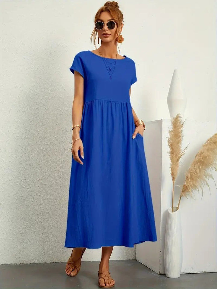 Casual women's flowing midi dress, ideal for summer days, featuring useful pockets.